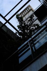 a building with a gate and a tree in front of it at 沐美美藝旅 Mumeimei Artel in Tainan