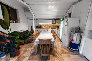 a kitchen with a table and chairs and a refrigerator at Vila H2O in Mangalia
