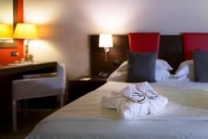 A bed or beds in a room at Hotel Parma & Congressi
