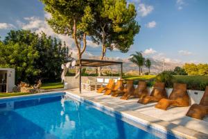 a swimming pool with a bunch of chairs next to it at MIMAR ALTEA VILLA l in Altea