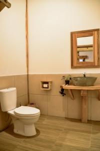 a bathroom with a toilet and a sink at Beda gaya ecolodge Rangsot 1 in Tanjung +23 photos