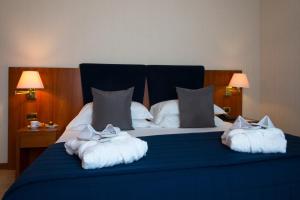A bed or beds in a room at Hotel Parma & Congressi