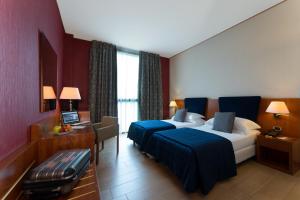 A bed or beds in a room at Hotel Parma & Congressi
