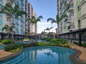 a swimming pool in the middle of some apartment buildings at Casa Aurora in Mandaue City