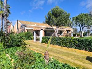 a house with a garden in front of it at Hacienda La Celada CARMONA SEVILLA in La Celada