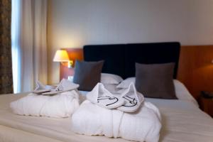 A bed or beds in a room at Hotel Parma & Congressi