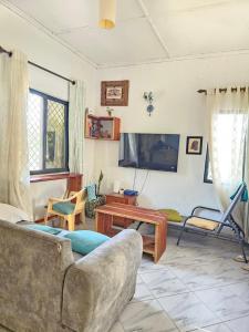 a living room with a couch and a table at Casalola in Mombasa