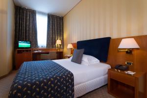 A bed or beds in a room at Hotel Parma & Congressi