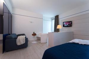 A bed or beds in a room at Hotel Parma & Congressi