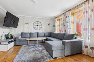 a living room with a couch and a table at Brygge Sjøgata in Mosjøen