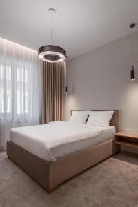 a bedroom with a large bed and a large window at Oasis Rooms Oradea in Oradea