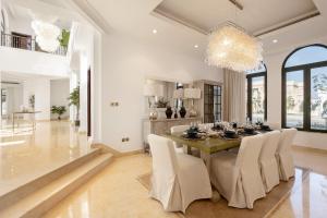 a dining room with a table and chairs at Maison Privee - Villa on Beach with Private Pool The Palm Jumeirah in Dubai +24 photos