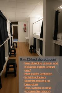 a room with bunk beds and stools in it at Cozy Nook in Valencia