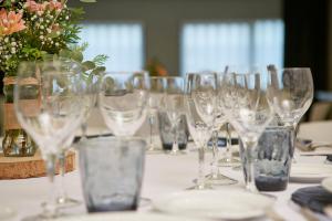a bunch of wine glasses sitting on a table at Sercotel Rosaleda Málaga in Málaga
