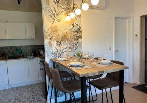 a dining room table with chairs and wine glasses at Meuse Cottage in Hastière-par-delà