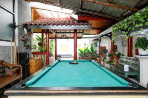 a pool table in the middle of a patio at RedDoorz near Jawa Timur Park 1 in Batu