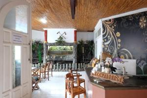 a dining room with chairs and a fireplace at RedDoorz near Jawa Timur Park 1 in Batu