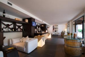 a living room filled with furniture and a large window at CDH Hotel Radda in Radda in Chianti