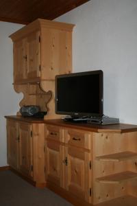 a computer on top of a wooden dresser at Hus Pravis in Klosters