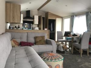 a living room with a couch and a table at Moray Coast getaway in Lossiemouth