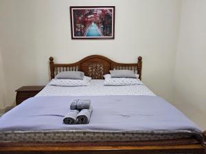 a bedroom with a bed with blue sheets and two rolls at Apple Bungalows in Bang Saphan +57 photos