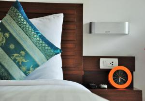 a bedroom with a bed with an orange clock next to it at Family House Zen Boutique Resort in Pai