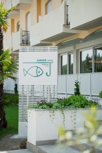 a sign in front of a house with a fish on it at Junior Family Hotel in Cavallino-Treporti