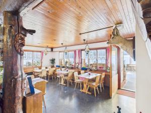 a restaurant with wooden ceilings and tables and chairs at Hotel Wildbach Brienz - Self Check-in in Brienz +58 photos