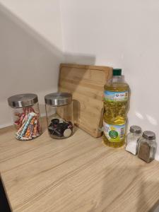 a wooden shelf with a bottle of honey and jars at Appart proche gare centre ville bureau parking in La Loupe