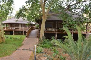 a house with a walkway in front of it at Stoep At Steenbok Self Catering in Komatipoort