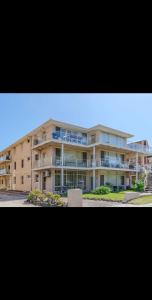 a large apartment building with a lot of balconies at Top Location Beachside Apartment in Cronulla