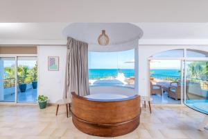 a room with a bed and a view of the ocean at Villa Verde Azura in Bin Rhilouf +43 photos