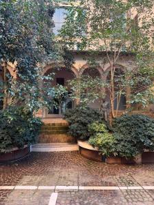 a building with stairs and trees in front of it at Nuovo Fiore in Pesaro