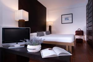 a bed room with a desk and a computer on it at CDH Hotel Radda in Radda in Chianti