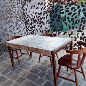 a wooden table with four chairs sitting around it at Gabriella Vendégház in Vadna