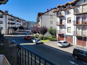 a city street with cars parked on the street at Apartamento Baztangoa II Centro Elizondo in Elizondo