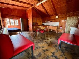 a room with a table and chairs and a kitchen at Backpackers at Kanaan in Hazyview +8 photos