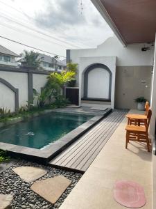a swimming pool in the middle of a patio at Twin House Villa in Canggu