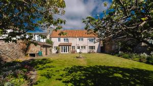 a large white house with a large yard at New Haven in Elie