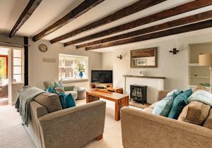 a living room with two couches and a fireplace at New Haven in Elie