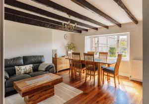 a living room with a table and chairs and a couch at New Haven in Elie