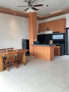 a large kitchen with a table and chairs at Twin House Villa in Canggu