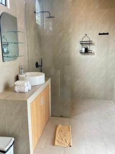 a bathroom with a sink and a shower at Twin House Villa in Canggu +10 photos