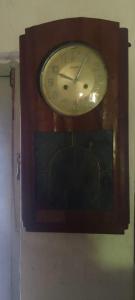 a wooden clock hanging on a wall at Lakeview since 1963 in Pilawala