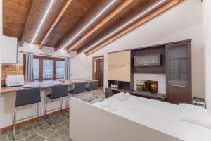 a living room with a fireplace and a table and chairs at EasyHome Malpensa Milano - self-check-in in Somma Lombardo