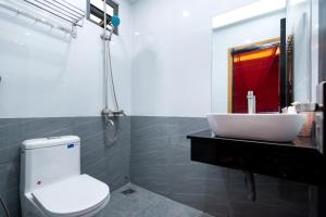 a bathroom with a sink and a toilet and a mirror at E Stay Boutique in Vung Tau +38 photos
