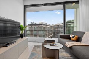 a living room with a couch and a large window at Urban Heights - Apartment in St Julian's in St. Julianʼs