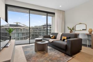 a living room with a couch and a large window at Urban Heights - Apartment in St Julian's in St. Julianʼs