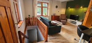 a living room with a couch and a chair at Rest & Relax Górzyniec in Piechowice