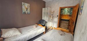 a room with two beds and a couch in it at Rest & Relax Górzyniec in Piechowice